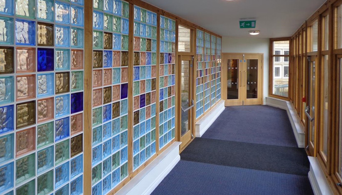 A corridor with a wall of glass blocks.