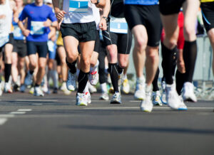A shot of the legs of a crowd of runners doing a marathon