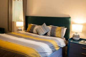 The bedroom in the Snowflake Suite, showing a large bed with side tables and lamps.