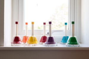 A set of small multicoloured bells sat on the windowsill in the music therapy room.