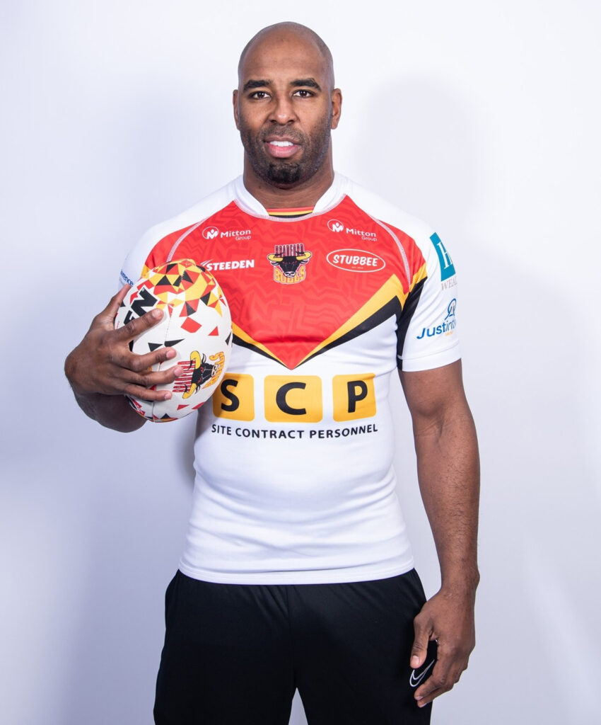 Rugby player Michael Lawrence holding a rugby ball