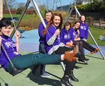 Members of our team on the swings in the Forget Me Not gardens.