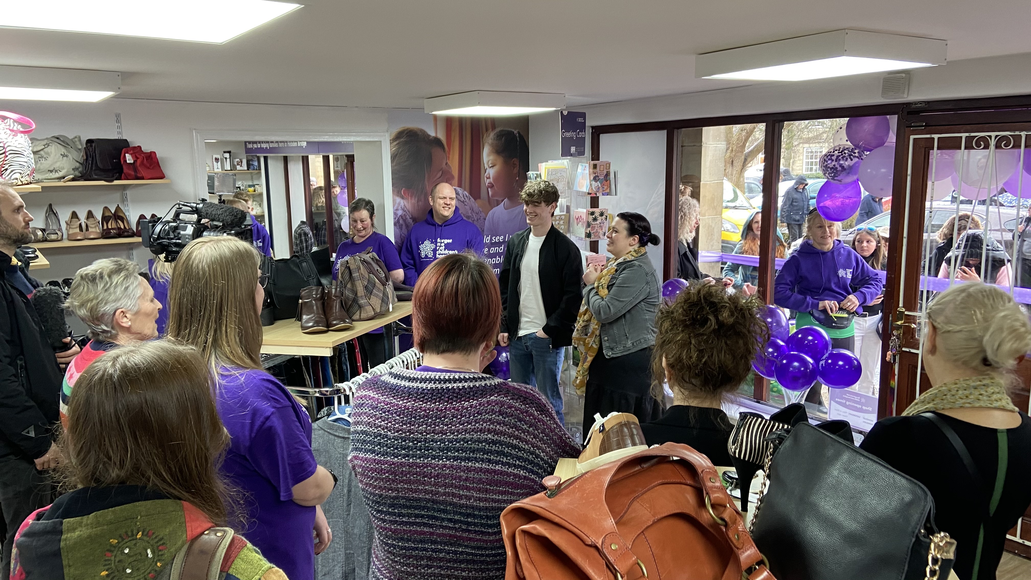 Rhys Connah meets volunteers in Forget Me Not charity shop